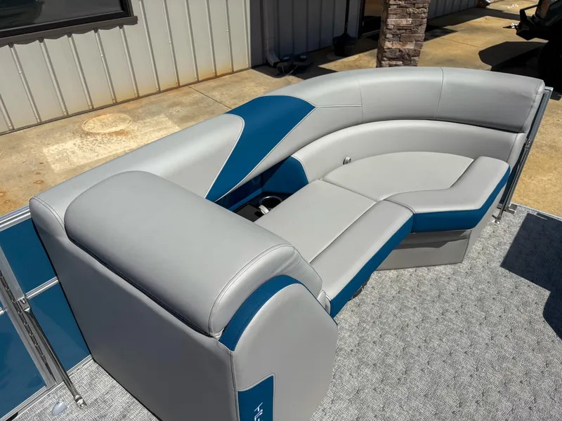 Slide: The Image of 2025 Trifecta 22 RF LE boat seating with gray and blue upholstery, outdoor setting. - 7