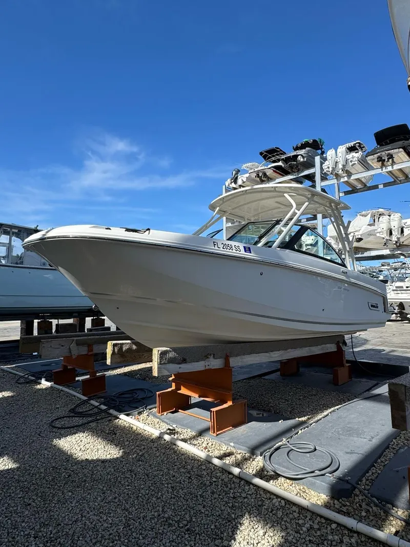 Slide: The Image of 2020 Boston Whaler 230 Vantage boat on dry dock under clear blue sky. - 2