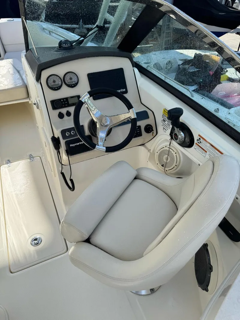Slide: The Image of 2020 Boston Whaler 230 Vantage boat cockpit with steering wheel and control panel. - 5