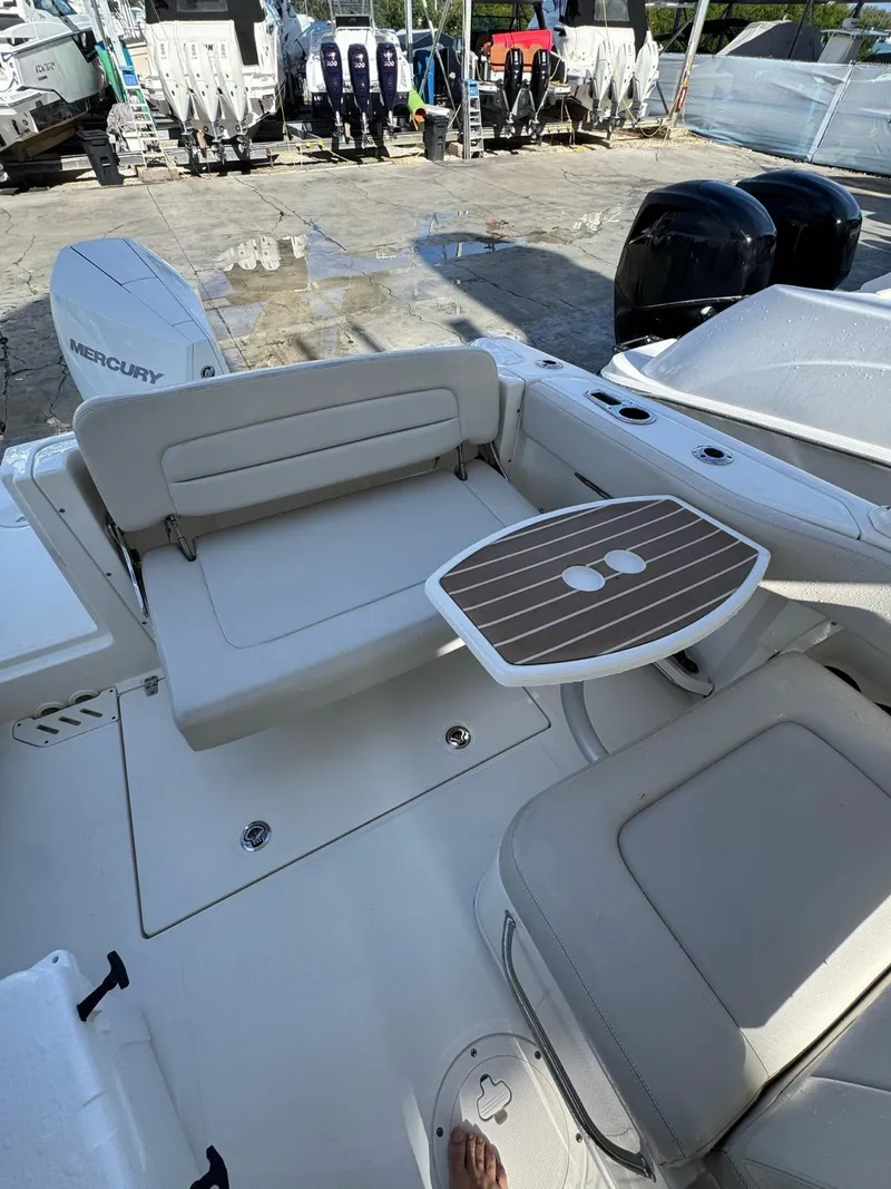 Slide: The Image of 2020 Boston Whaler 230 Vantage boat interior with seating and table setup. - 6