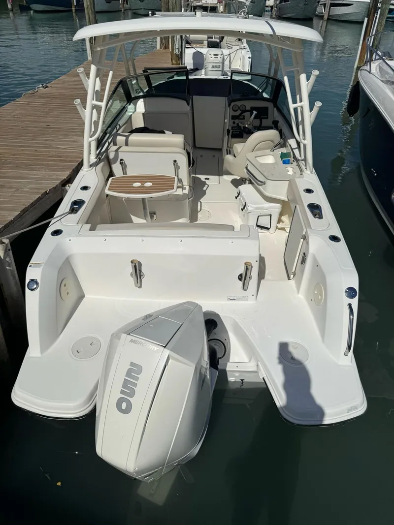 Slide: The Image of 2020 Boston Whaler 230 Vantage boat docked, showcasing spacious seating and modern design. - 8