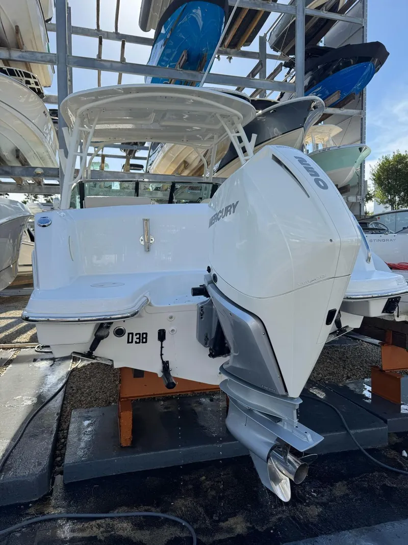 Slide: The Image of 2020 Boston Whaler 230 Vantage boat with Mercury engine, docked in a marina. - 9