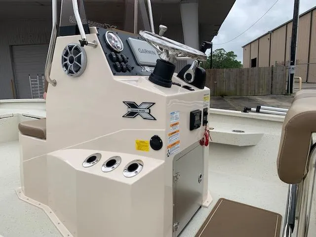 Slide: The Image of 2024 Xpress H22 boat console with steering wheel and controls, featuring modern design elements. - 3