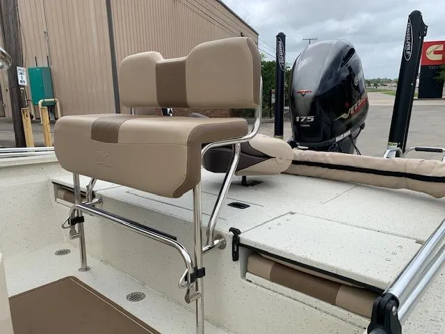 Slide: The Image of 2024 Xpress H22 boat with beige seating and powerful outboard motor. - 4