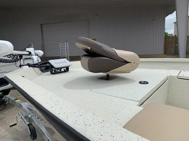 Slide: The Image of 2024 Xpress H22 boat with beige seating and Garmin equipment on deck. - 5