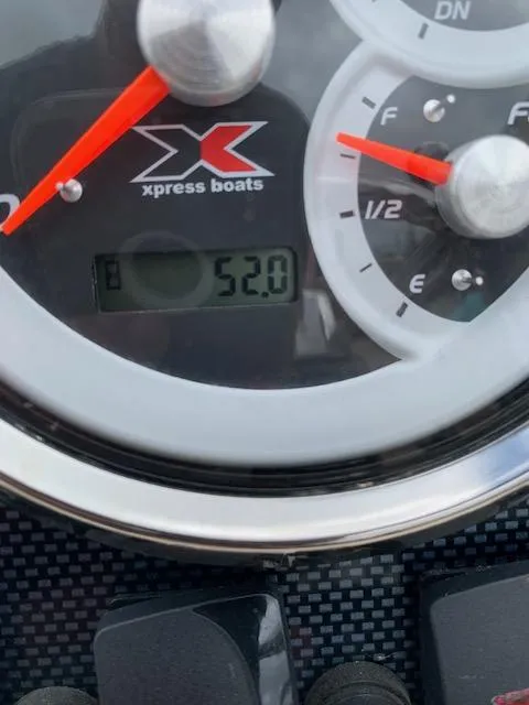Slide: The Image of 2024 Xpress H22 boat dashboard showing fuel gauge and digital display reading 52.0. - 7