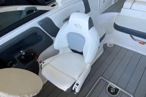 Slide: The Image of 2022 Chaparral 267 SSX OB boat interior with white seating and gray flooring. - 16