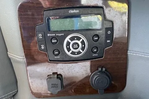Slide: The Image of Clarion audio system on 2022 Chaparral 267 SSX OB boat dashboard. - 22