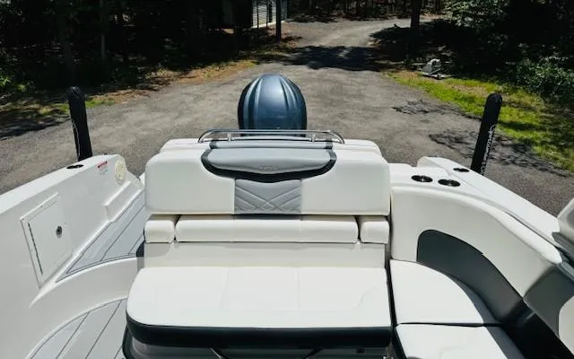 Slide: The Image of 2022 Chaparral 267 SSX OB boat with sleek white seating and modern design. - 4