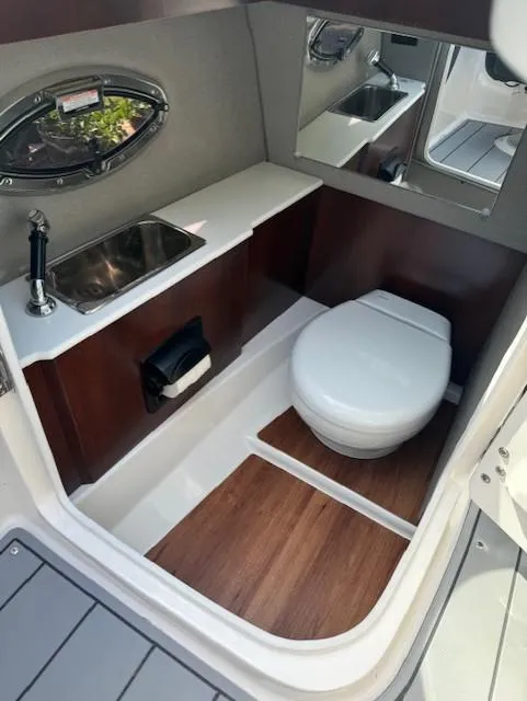 Slide: The Image of 2022 Chaparral 267 SSX OB boat interior with sink and toilet. - 6