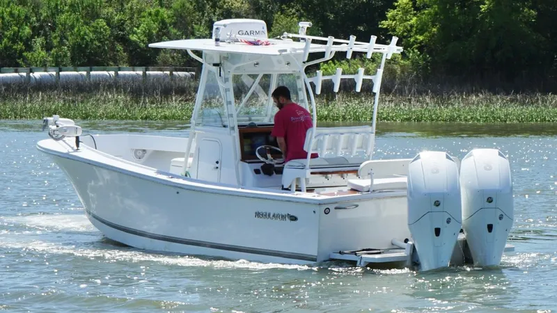 Slide: The Image of 2000 Regulator 26 Classic boat cruising on a sunny day with dual engines. - 12