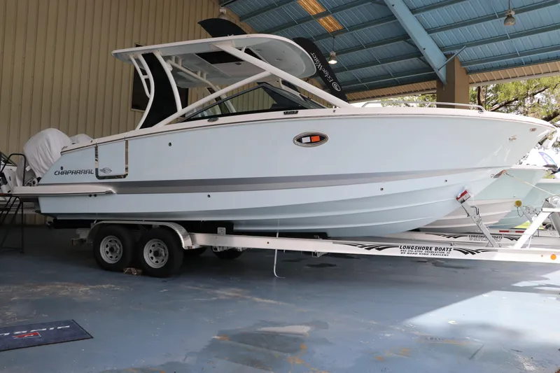 The Image of 2025 Chaparral 280 OSX boat on trailer in covered storage area. - 0