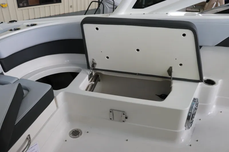 Slide: The Image of 2025 Chaparral 280 OSX boat interior storage compartment with open lid. - 15