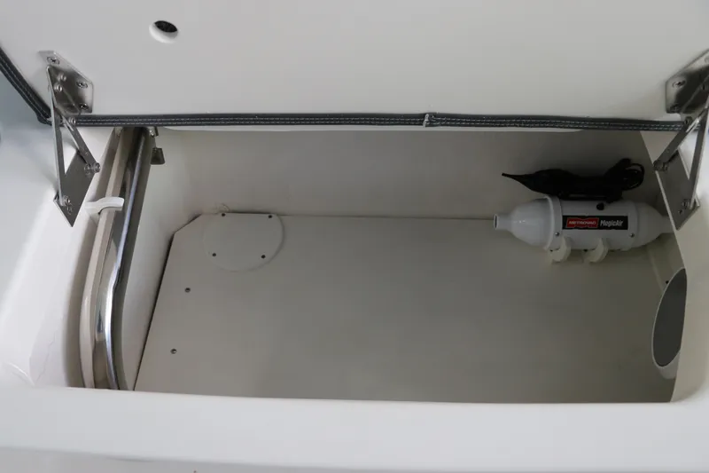 Slide: The Image of Storage compartment in 2025 Chaparral 280 OSX boat with Magic Air inflator. - 17