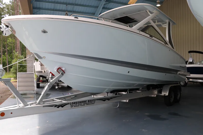 Slide: The Image of 2025 Chaparral 280 OSX boat on trailer in covered storage area. - 2
