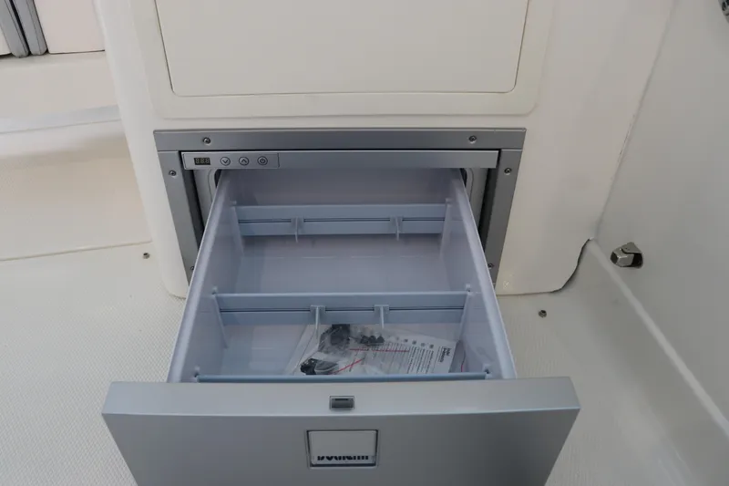 Slide: The Image of 2025 Chaparral 280 OSX boat drawer with digital control panel, open and empty. - 22