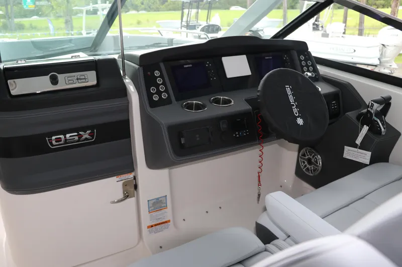 Slide: The Image of 2025 Chaparral 280 OSX boat dashboard with modern controls and steering wheel. - 29