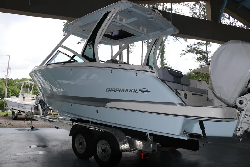 Slide: The Image of 2025 Chaparral 280 OSX boat on trailer, under shelter, side view. - 3