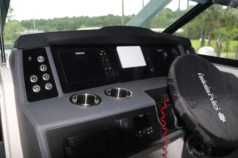 Slide: The Image of 2025 Chaparral 280 OSX helm with modern controls and dual cup holders. - 30