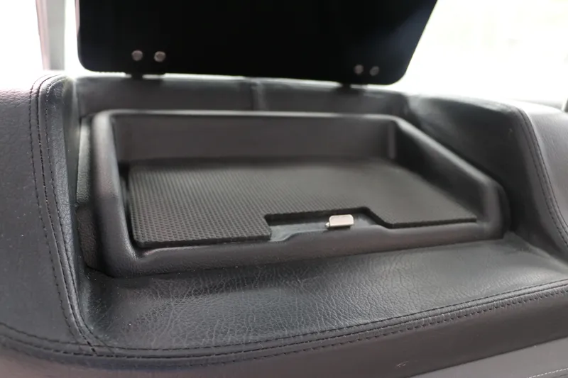 Slide: The Image of 2025 Chaparral 280 OSX dashboard storage compartment with black leather trim. - 34