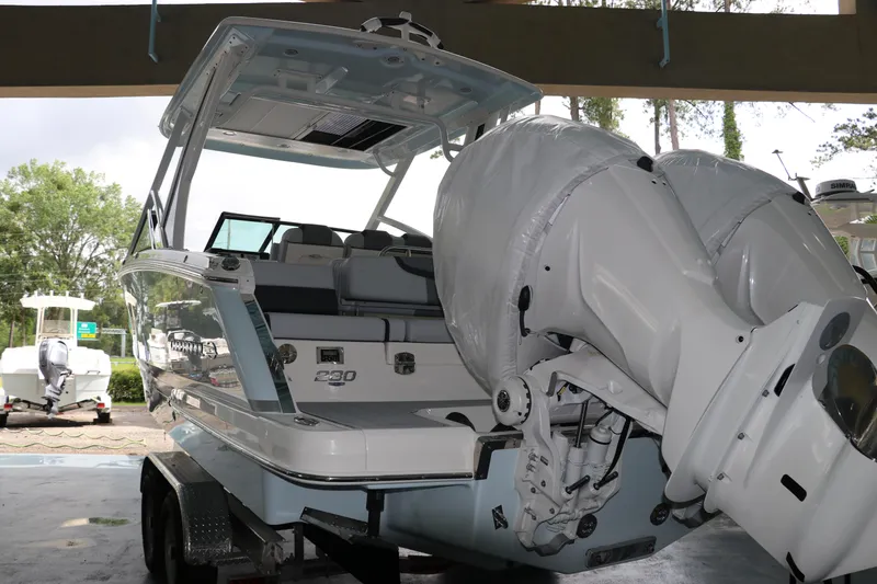 Slide: The Image of 2025 Chaparral 280 OSX boat with dual engines on a trailer, parked indoors. - 4