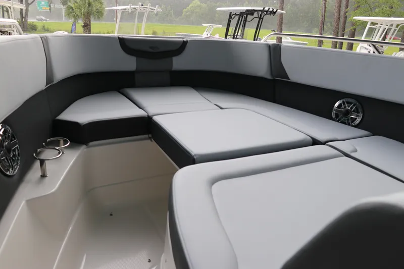 Slide: The Image of 2025 Chaparral 280 OSX boat interior with cushioned seating and cup holders. - 44
