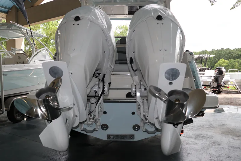 Slide: The Image of 2025 Chaparral 280 OSX boat with dual outboard engines, displayed in a showroom. - 6