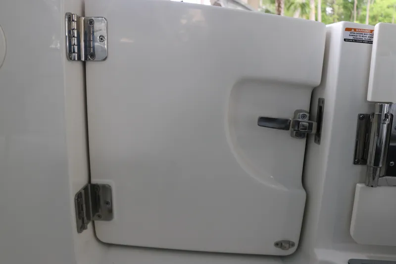 Slide: The Image of 2025 Chaparral 280 OSX boat door with stainless steel hinges and latch. - 9