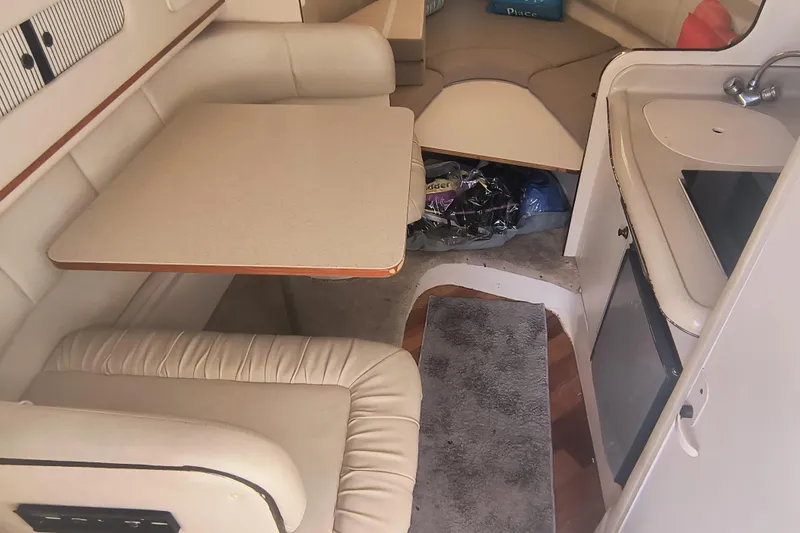 Slide: The Image of Interior of 2000 Sea Ray 270 Sundancer with seating, table, and kitchenette. - 10
