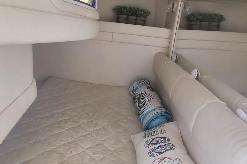 Slide: The Image of Interior cabin of 2000 Sea Ray 270 Sundancer with cozy bedding and decor. - 14