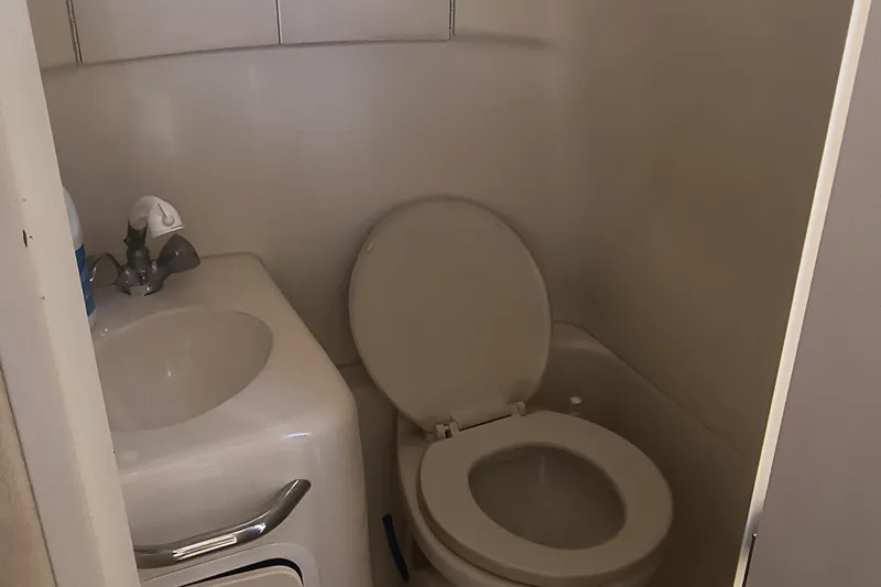 Slide: The Image of Compact bathroom in 2000 Sea Ray 270 Sundancer boat with sink and toilet. - 15