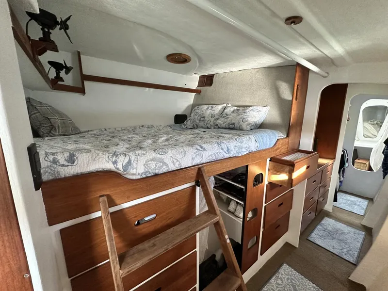 Slide: The Image of Interior of a 1972 Custom 53 Catamaran with cozy wooden bunk bed and storage. - 20