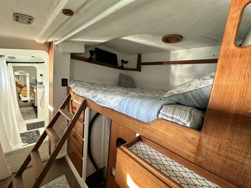 Slide: The Image of 1972 Custom 53 Catamaran interior with wooden bunk bed and storage. - 21