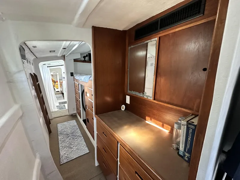 Slide: The Image of Interior of a 1972 Custom 53 Catamaran with wooden cabinetry and hallway view. - 23