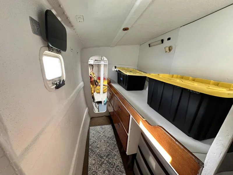 Slide: The Image of Interior of a 1972 Custom 53 Catamaran with storage bins and wooden cabinetry. - 26