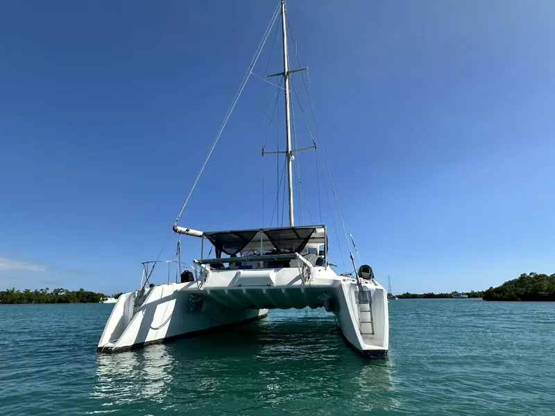 Slide: The Image of 1972 Custom 53 Catamaran sailing on calm blue waters under clear sky. - 3