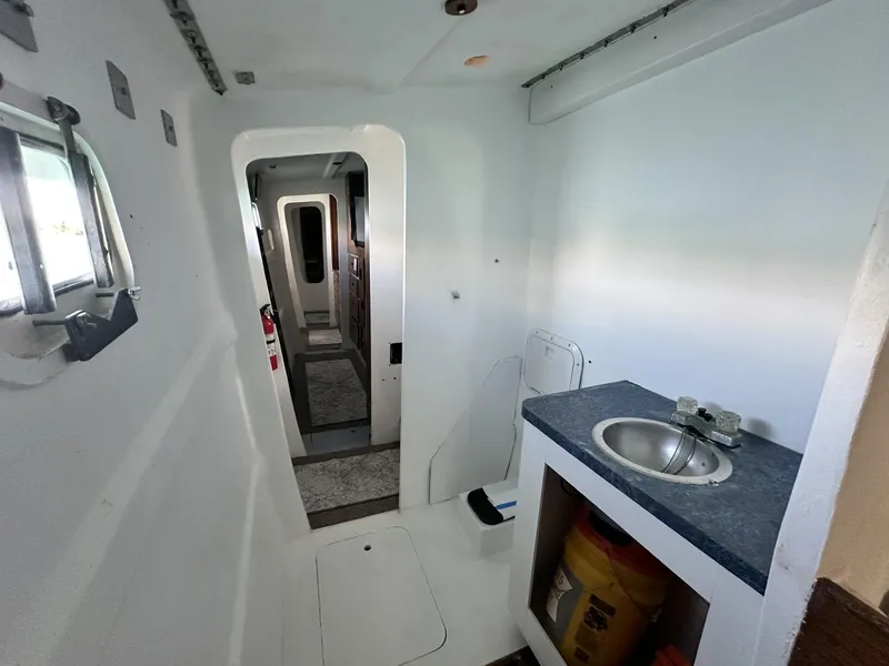 Slide: The Image of Interior of a 1972 Custom 53 Catamaran featuring a compact sink and corridor. - 30