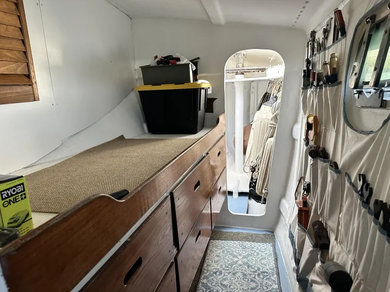Slide: The Image of Interior of a 1972 Custom 53 Catamaran with storage and tools. - 31
