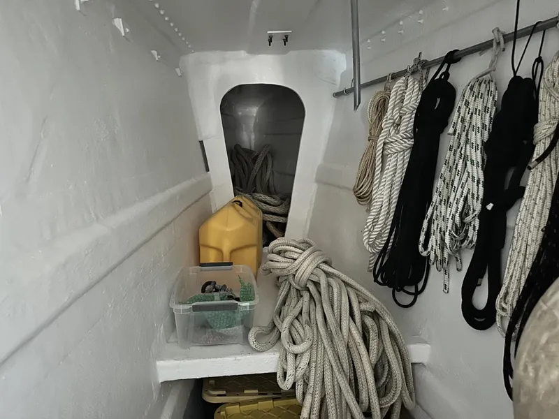 Slide: The Image of Interior of a 1972 Custom 53 Catamaran with ropes and storage items. - 35