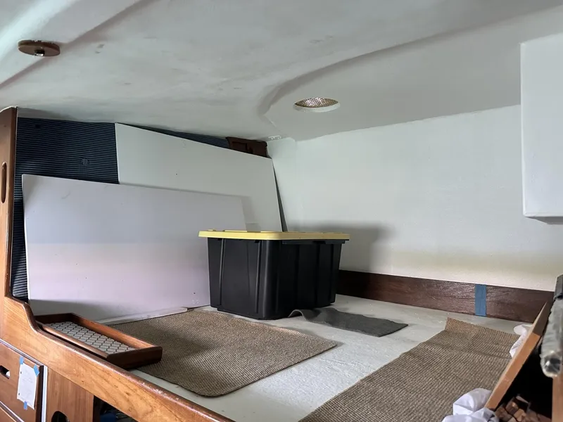 Slide: The Image of Interior of a 1972 Custom 53 Catamaran with storage bin and wooden accents. - 36