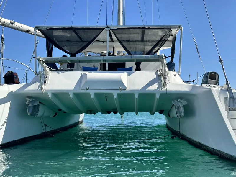 Slide: The Image of 1972 Custom 53 Catamaran on turquoise water, rear view showcasing twin hulls and deck. - 37