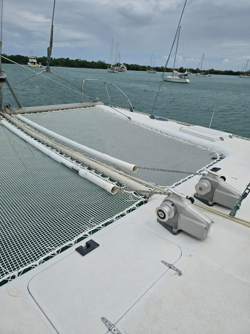 Slide: The Image of 1972 Custom 53 Catamaran on calm waters with visible netting and winches. - 40