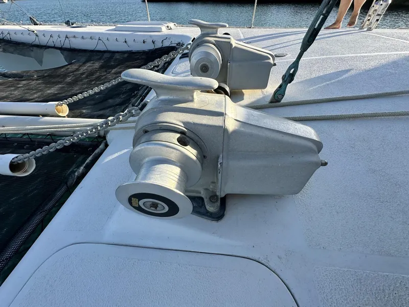 Slide: The Image of 1972 Custom 53 Catamaran deck with winch and chain, docked by the water. - 44