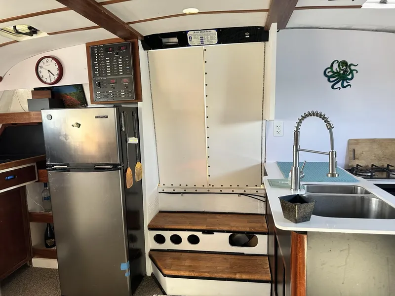 Slide: The Image of Interior of a 1972 Custom 53 Catamaran with kitchen and modern appliances. - 8