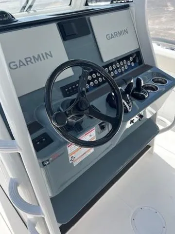 Slide: The Image of Edgewater 340CC 2024 boat console with Garmin displays and steering wheel. - 16