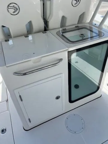 Slide: The Image of 2024 Edgewater 340CC boat interior with storage and sink area. - 19