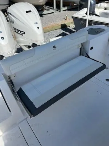 Slide: The Image of 2024 Edgewater 340CC boat with foldable seating and twin outboard engines. - 21