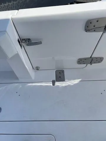 Slide: The Image of 2024 Edgewater 340CC boat deck with stainless steel hinges and latch. - 22