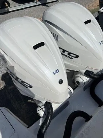 Slide: The Image of 2024 Edgewater 340CC boat with twin Yamaha V8 outboard engines. - 24