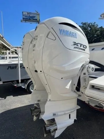 Slide: The Image of 2024 Edgewater 340CC with Yamaha XTO Offshore outboard engines displayed outdoors. - 28